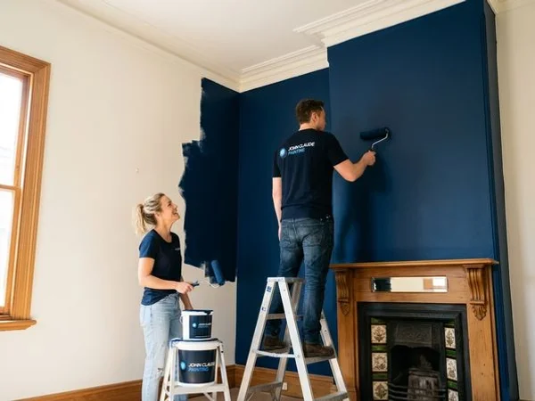 Modern Fitzroy living room with a deep navy feature wall freshly painted alongside warm white walls and timber floors